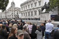 epa10192832 People wait for the State Funeral Procession of Queen Elizabeth II in London, Britain, 19 September 2022.  Britain's Queen Elizabeth II died at her Scottish estate, Balmoral Castle, on 08 September 2022. The 96-year-old Queen was the longest-reigning monarch in British history.  EPA/VINCE MIGNOTT