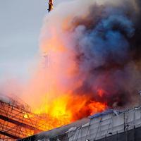 TOPSHOT - This photograph shows flames engulfing the Copenhagen's Stock Exchange building, in Copenhagen, on April 16, 2024. (Photo by Ida Marie Odgaard / Ritzau Scanpix / AFP) / Denmark OUT